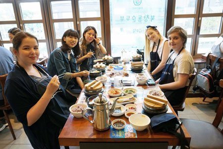 Students are enjoying Korean food for lunch after the morning Korean class