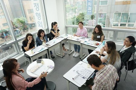 Students having a good time learning Korean in modern Rolling Korea facility