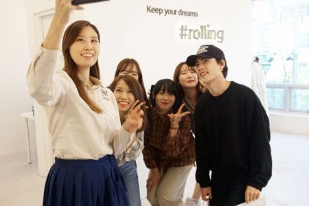 Students are taking selfie with the instructor while learning Korean in the class