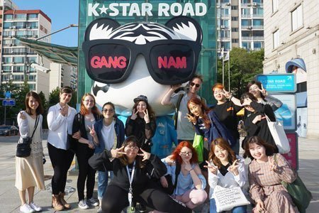 Students with K-POP doll at GangNam after learning Korean in the morning class